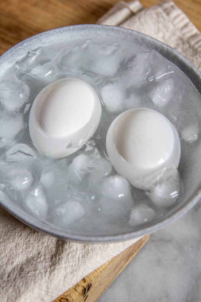Hard-boiled egg soaking in ice bath