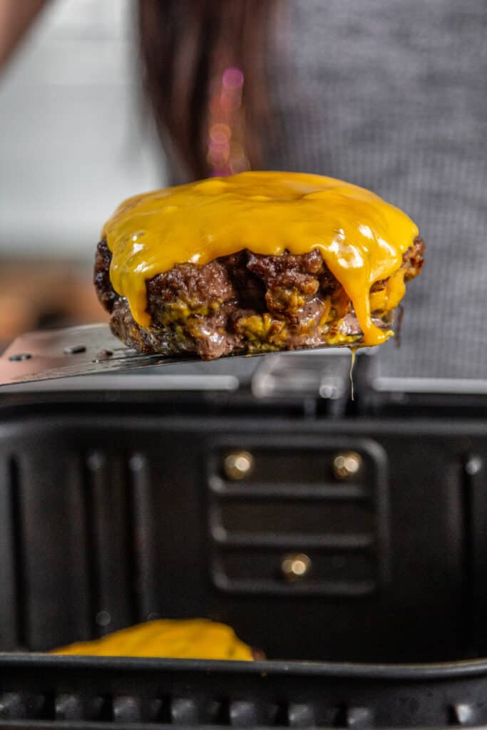 hamburger patty with melted cheese on it