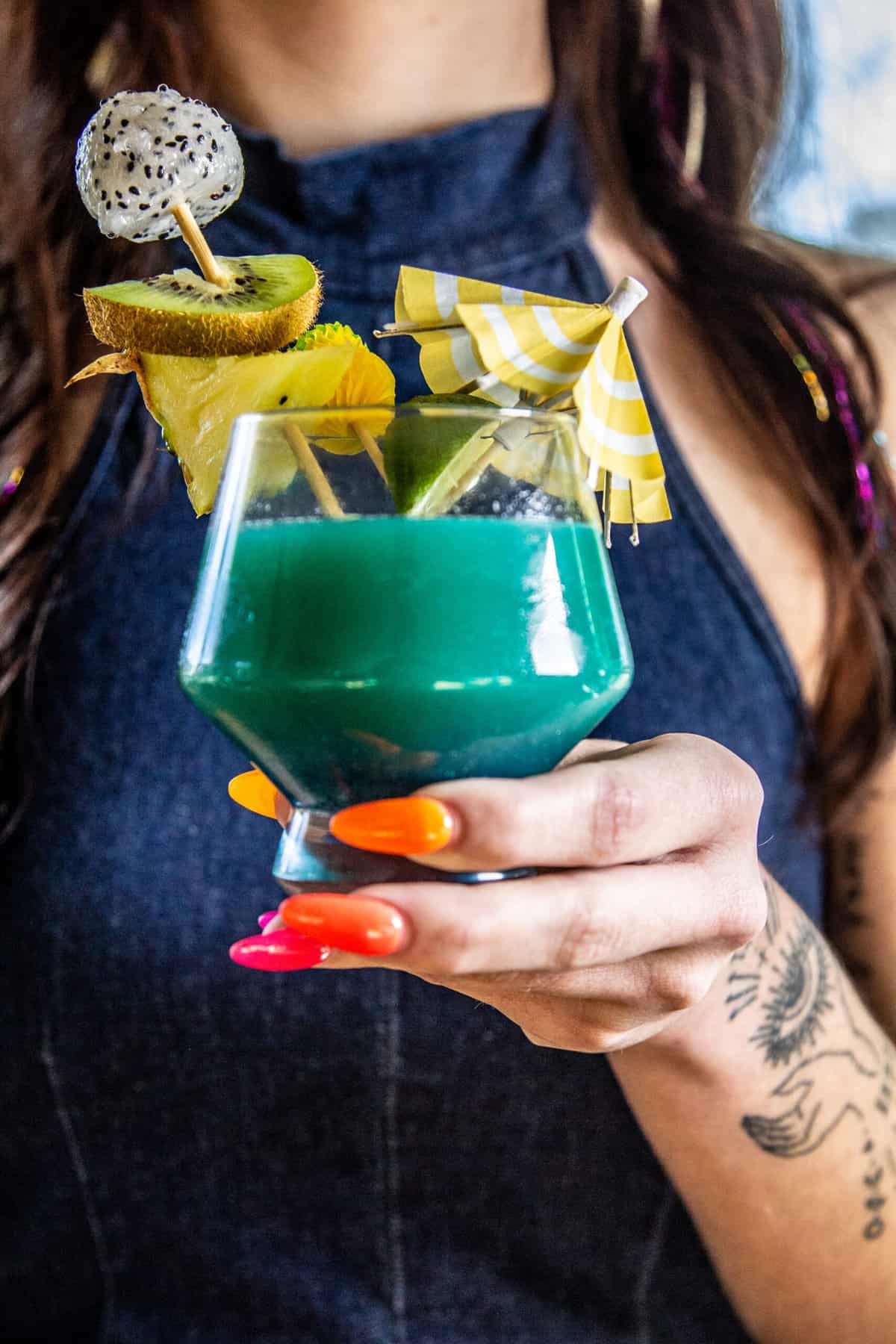 hand holding blue hawaii cocktail