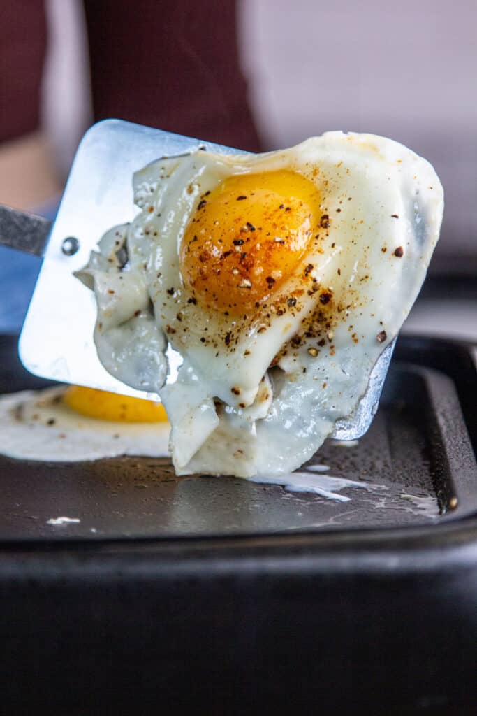 spatula flipping egg on griddle