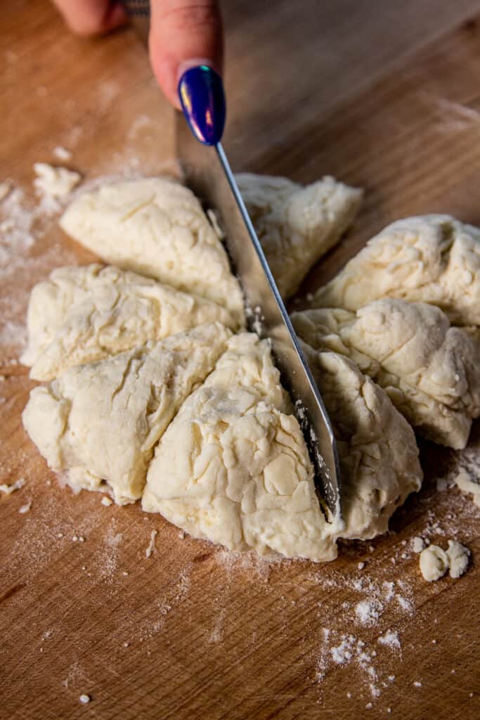 hand cutting dough into 8 pieces