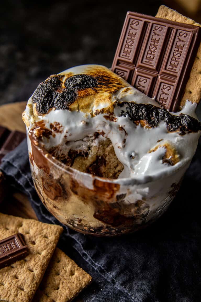 a mug with smores roll inside - on dark background