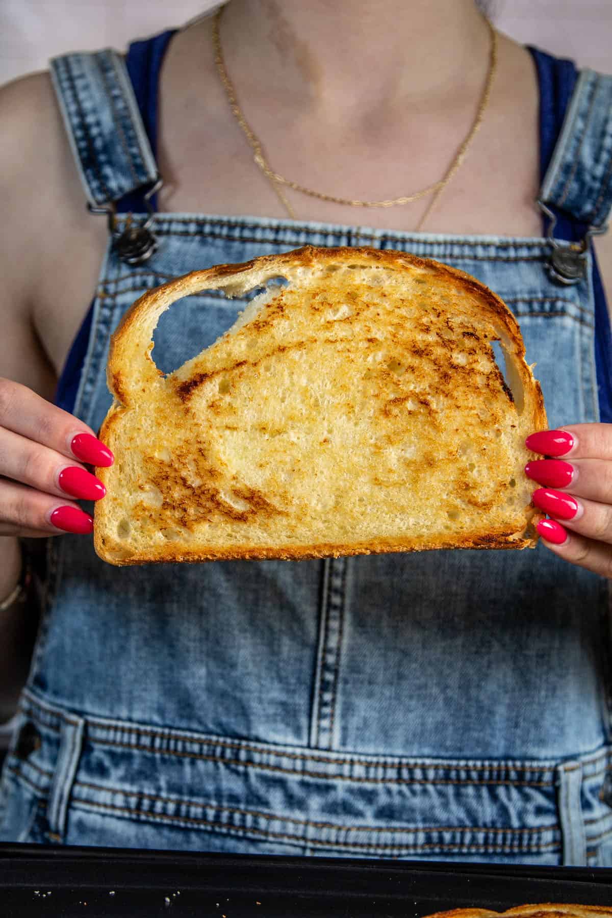 hand holding toasted bread