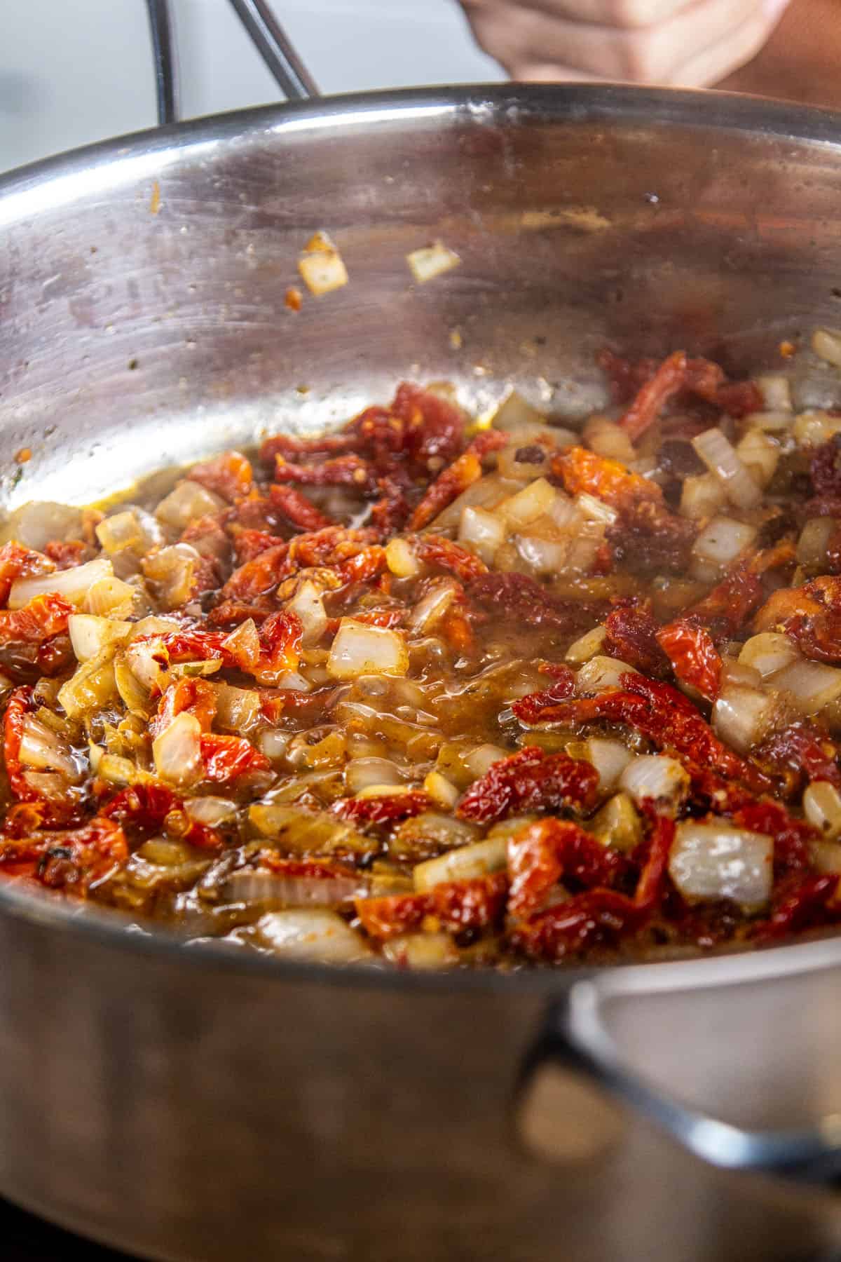 cooking onions & sundried tomatoes in pan