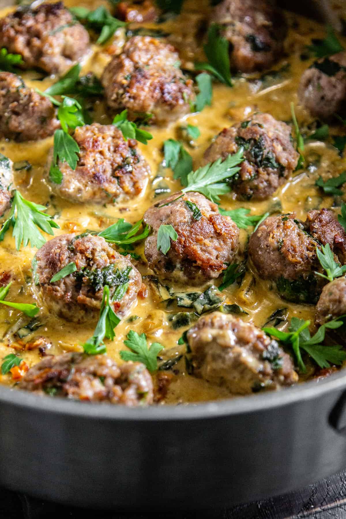 Side view of meatballs in sauce