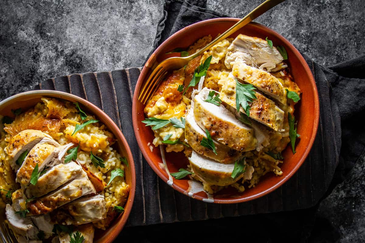 two bowls of no peek chicken on dark background